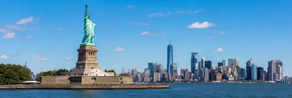Statue of Liberty overlooking New York Harbor with the Manhattan skyline in the background.