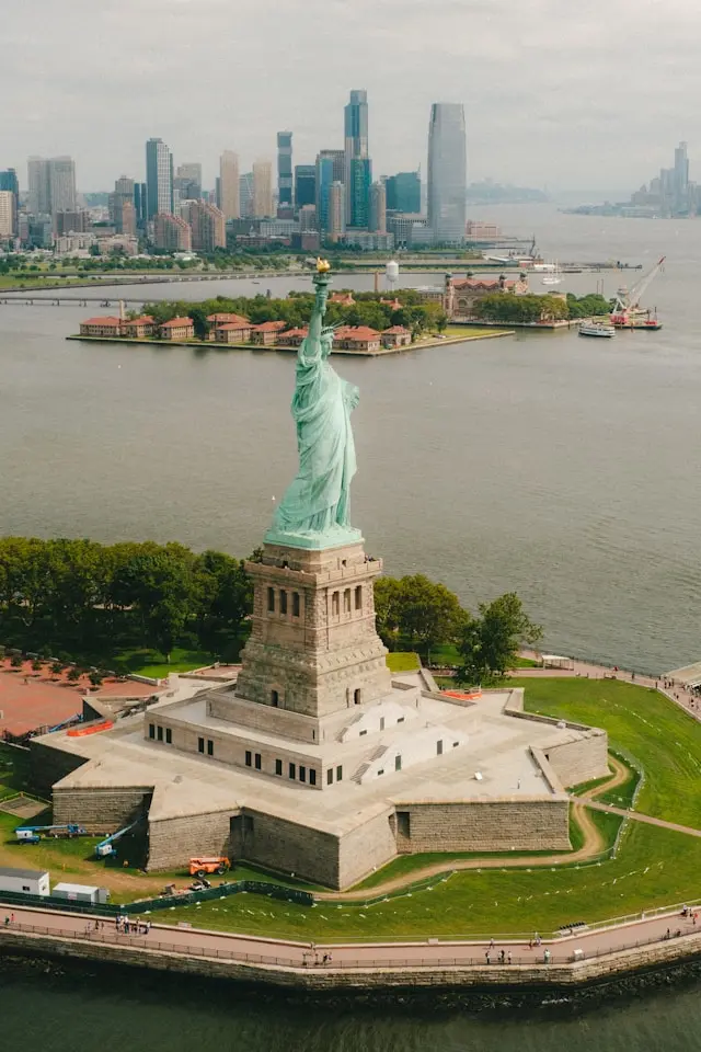 Statue of Liberty overlooking New York Harbor with Manhattan skyline in the background