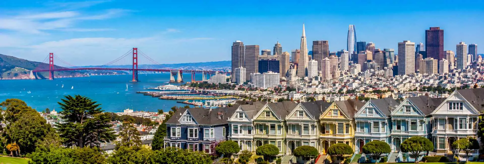San Francisco skyline with Golden Gate Bridge and colorful Victorian homes