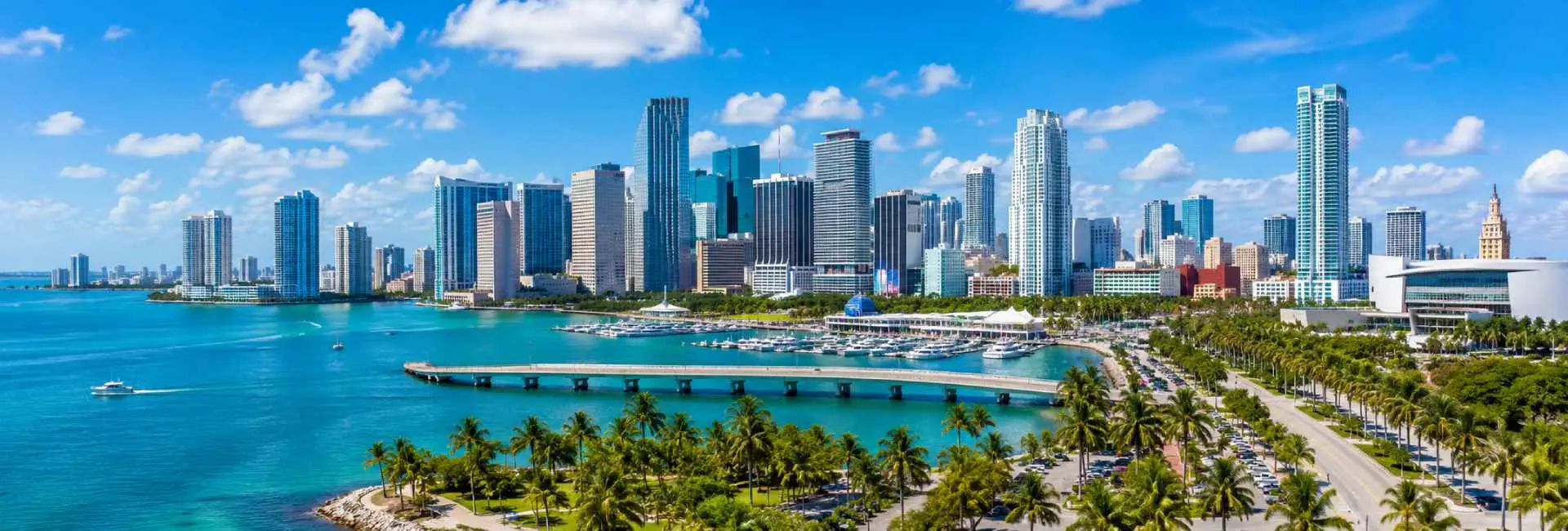 Miami, Florida skyline with turquoise waterfront and palm trees