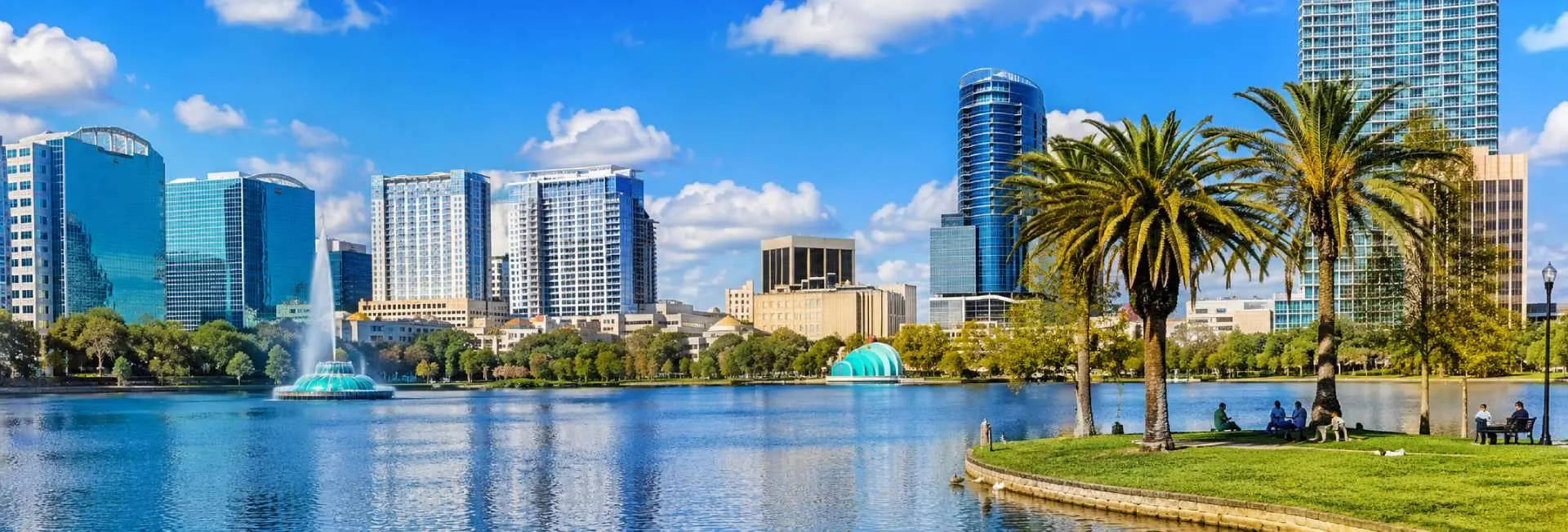 Orlando skyline and Lake Eola Park with fountain and palm trees in downtown Florida