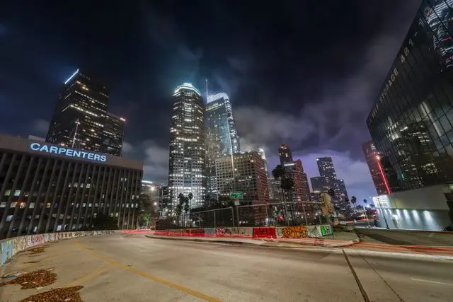 Downtown Los Angeles skyline illuminated at night with light trails