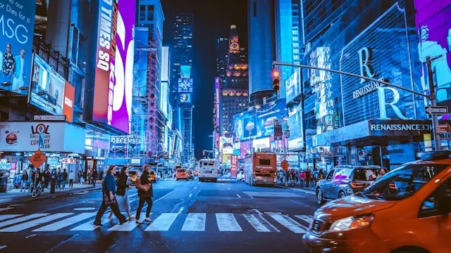 Times Square in New York City illuminated by colorful billboards and city lights at night